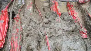 Wet ground cable joints covered in mud in wet trench